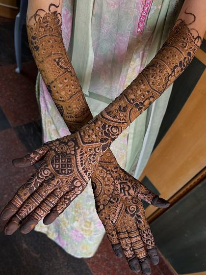 A crossed-hands pose showing the beautiful symmetry of the design. I also incorporated the groom's initial "R" into the palm.