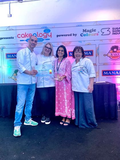 A precious moment on stage with the esteemed judges at Cakeology. Their encouragement means the world to me.