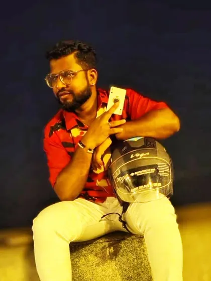 Taking a break with my helmet and a playing card. Magic is always on my mind, even when I'm off the stage. A smiling face makes the eyes happy.