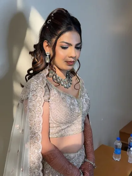 A moment of calm before the party. Her makeup is set to last through hours of dancing, ensuring she looks fresh all night.