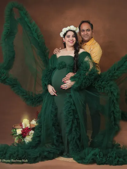 A stunning couple's portrait featuring our dramatic green ruffled gown. The partner's presence adds a layer of intimacy and support to this powerful, high-fashion look.