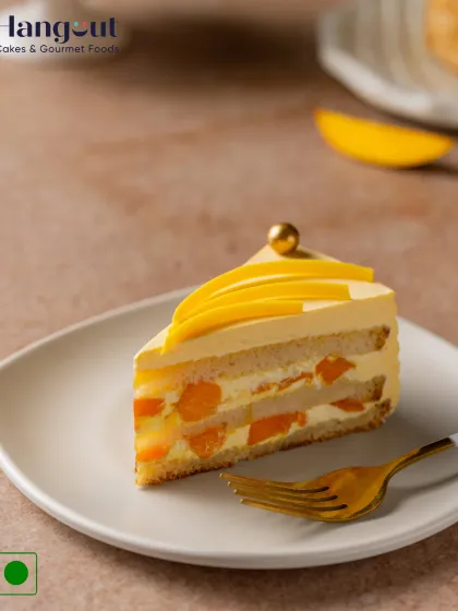 A slice of our Mango Magic Pastry is a taste of summer. It's made with a fluffy sponge, luscious mango cream, and chunks of sweet Alphonso mango.