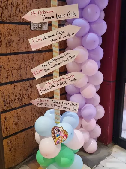A personalized milestone sign for a first birthday party. This cute detail shares fun facts about the birthday girl.