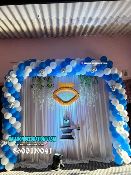 This naming ceremony decoration features a Shivling and Nandi, creating a divine theme for the baby's blessing. The blue and white balloon arch frames the sacred setup beautifully.