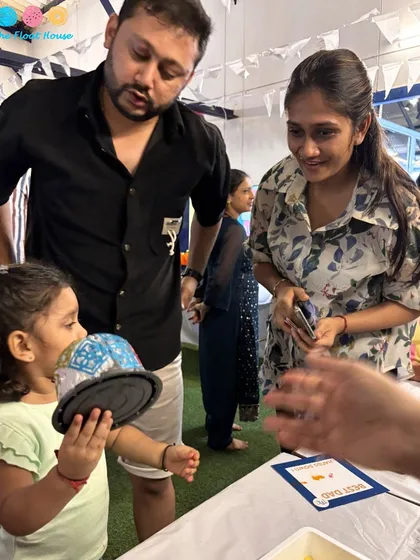 A family participating in a craft activity during our kids' club opening. Our studio spaces are not just for dancing; they are perfect for all kinds of workshops and family events.