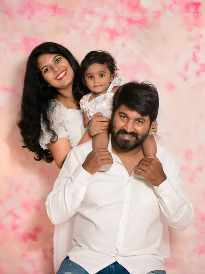 A fun family pose with the toddler sitting on her father's shoulders. I guide my clients into poses that feel natural and result in happy, connected family pictures.