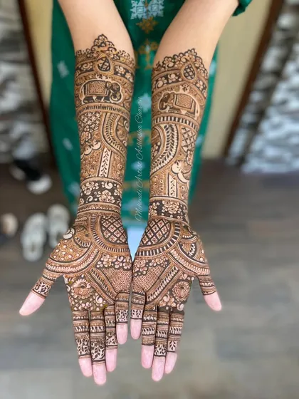 A beautiful bridal mehendi with elephant motifs. The design is a mix of traditional patterns, creating a rich and symbolic look for the bride.
