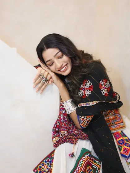 A serene and happy moment. The soft makeup look, with a simple bindi and defined eyes, is perfect for the spiritual and celebratory feel of Navratri.