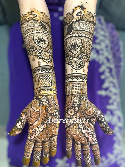 An elegant engagement design with peacock and lotus motifs, featuring delicate net patterns and a beautiful flow from hand to arm.