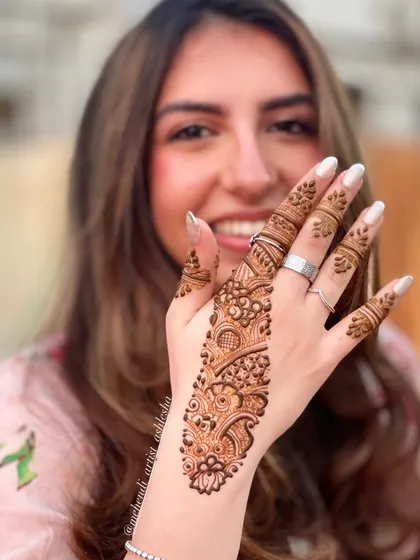 A happy client with her Arabic belt mehendi. This style is simple, elegant, and perfect for any occasion.