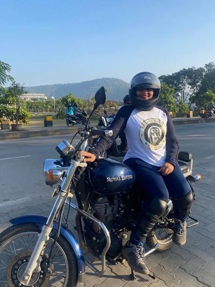 A graduate on her bike, wearing the Heels on Wheels jersey. She is a proud member of our riding tribe.