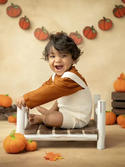 Another happy little pumpkin, enjoying the fun autumn setup.