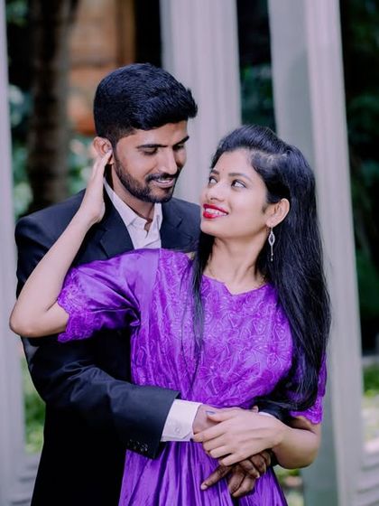 An intimate and romantic portrait of a couple in a garden setting.