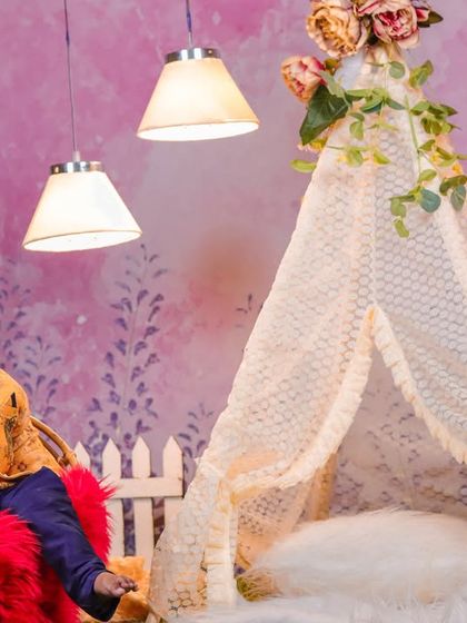 A cheerful moment in our pastel garden teepee set. The combination of the lace teepee, green turf, and soft pink floral background creates a bright and happy atmosphere.