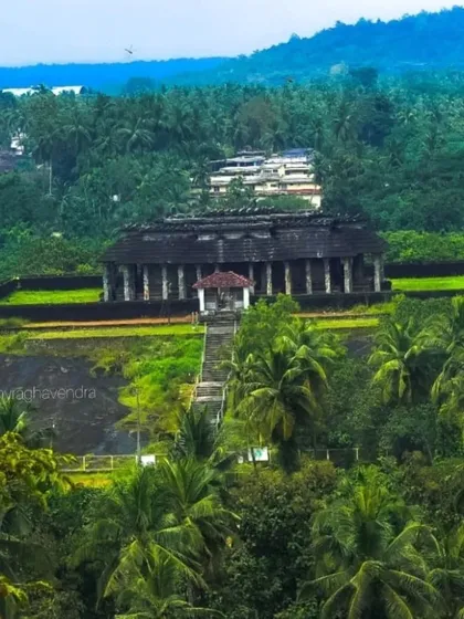 Another view of the ancient Jain temple in Karkala, surrounded by a sea of palm trees.