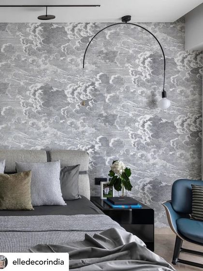 Featured in Elle Decor, this bedroom uses a dreamy cloud-print wallpaper to create an ethereal escape from the city. The arching floor lamp and serene grey bedding contribute to the calm and personal atmosphere.