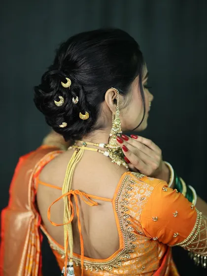 A view of the elegant bridal bun adorned with crescent moon accessories, a popular choice for modern Maharashtrian brides who love a touch of tradition.