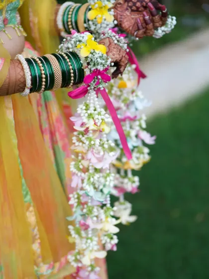 A detailed shot of the multi-colored kalire. I use a variety of fresh flowers like roses, baby's breath, and chrysanthemums to create these intricate and colorful designs.