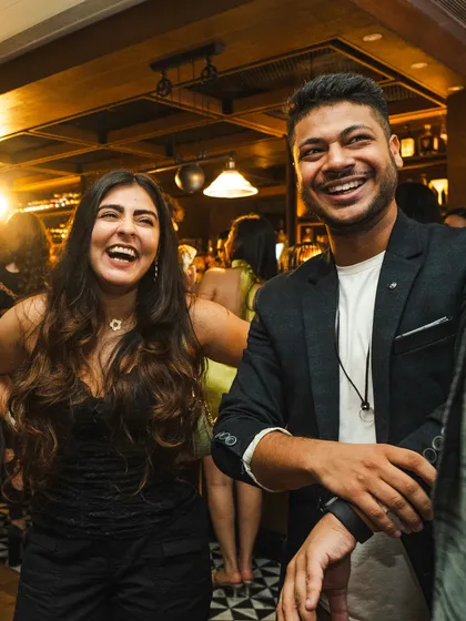 Sharing a laugh with a guest at the Hendrick's Gin show. My style is interactive and fun, ensuring that the entertainment feels like a natural part of the party.