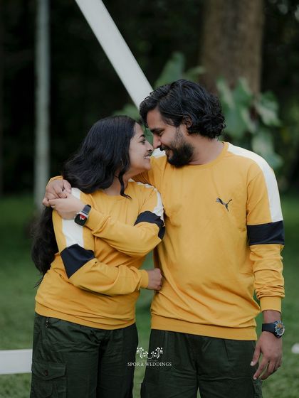 The couple embracing, their foreheads touching, a simple and powerful portrait of their love.