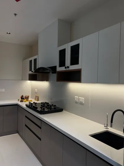 A close-up of the kitchen countertop, highlighting the under-cabinet lighting that provides excellent task lighting while adding to the room's ambiance.