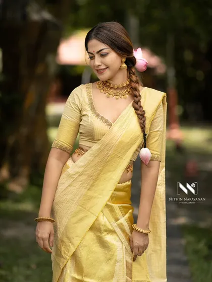 Anusree looking radiant in the golden kasavu saree. The natural setting of the resort provided a beautiful backdrop.
