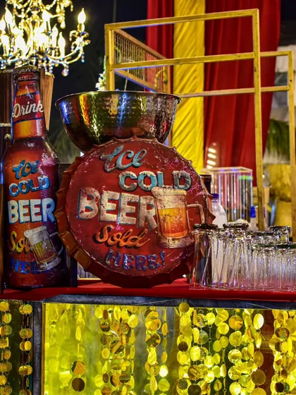 A fun, retro-themed beer station. I used vintage-style signs and a golden, shimmering facade to create a vibrant and casual spot for guests to grab an ice-cold beer.