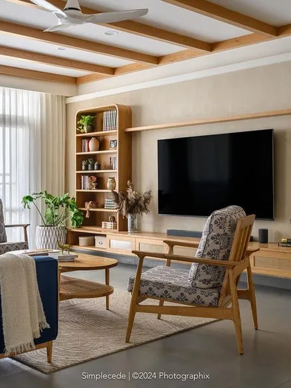 The living area in 'Cover me in Sunshine' features a theme of curves and straight lines. The TV and curio unit echoes the arched entryways, while ceiling rafters add strong character to the space.