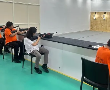 Students from Candor International School during their training session. We partner with local schools to introduce shooting as a sport that develops concentration and mental discipline.