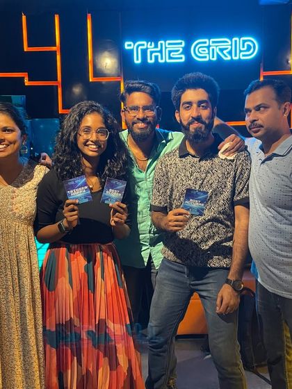 A group of friends holding up their prize cards.