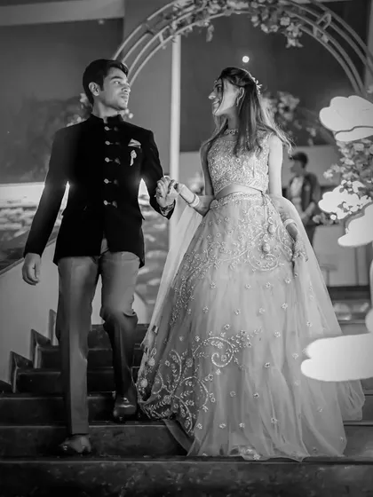 I often use black and white to add a touch of drama and timeless elegance. This shot from an engagement ceremony captures the couple's grand entrance, focusing on their expressions and the beautiful flow of the bride's gown.