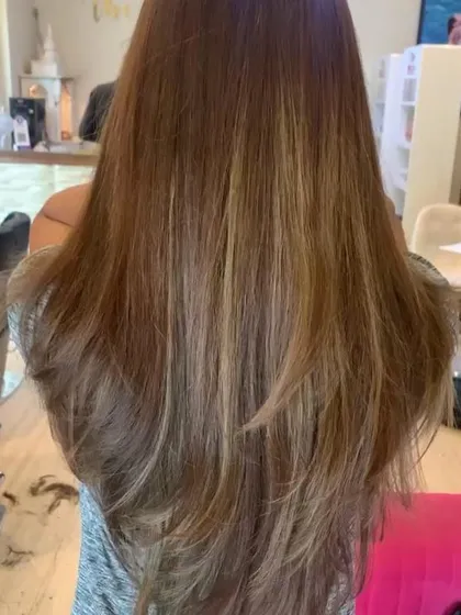 The same beautiful long-layered haircut, a testament to our focus on creating flattering and manageable styles.