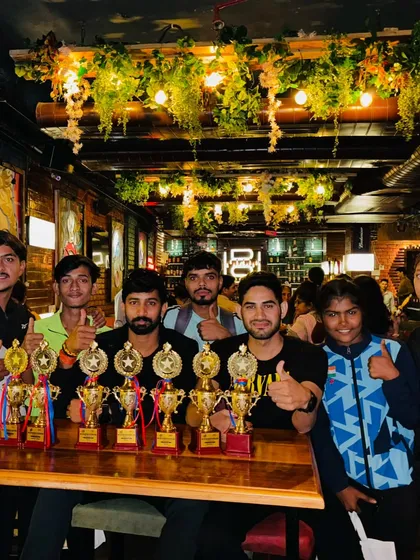 A celebratory dinner with my athletes and their haul of trophies. We work hard and celebrate our successes together as a team.