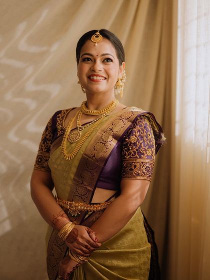 A full-length shot showing her elegant posture and the beautiful drape of her saree.