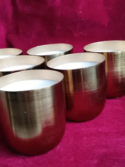 Another angle of the brass jar candles, showing their brushed finish.