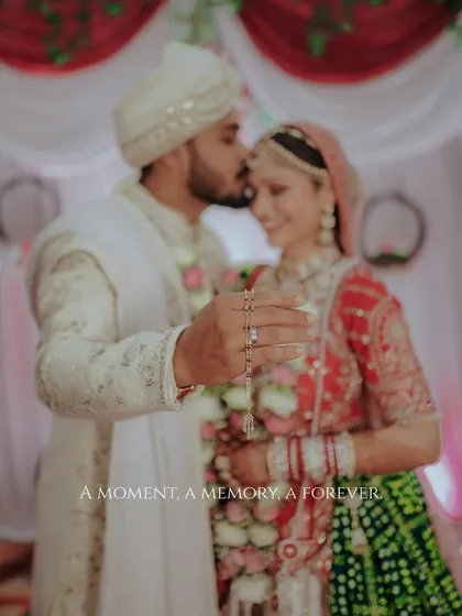 A moment, a memory, a forever. This beautifully soft-focus shot captures a tender kiss on the forehead, with the bride's ring in sharp focus, symbolizing the promise just made.
