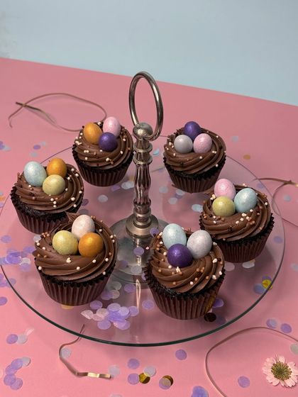 Our Easter Egg's Nest cupcakes are a favorite. Decadent chocolate cupcakes are frosted with a rich whipped chocolate ganache and topped with mini chocolate Easter eggs.