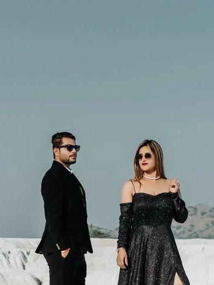A close-up of the couple's stylish and confident pose, showcasing their modern outfits and the high-fashion feel of the shoot.