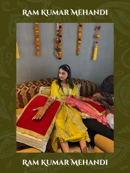 A candid shot of a bride during her mehandi session, looking on as I create her beautiful design.