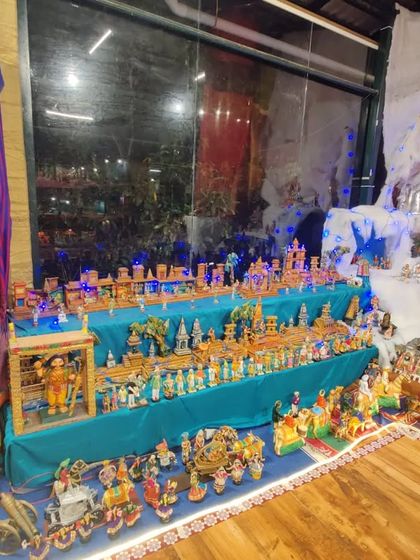 Another perspective of our doll exhibition, showing the wooden flooring and the arrangement of displays that allow for an intimate viewing experience. Each section tells a different story, inviting close observation.