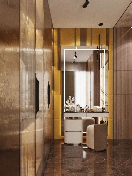 A glimpse into a high-end dressing room, where metallic and textured wall panels create a glamorous atmosphere. The illuminated vanity mirror provides perfect lighting for getting ready, reflecting the room's rich materials and sophisticated design.