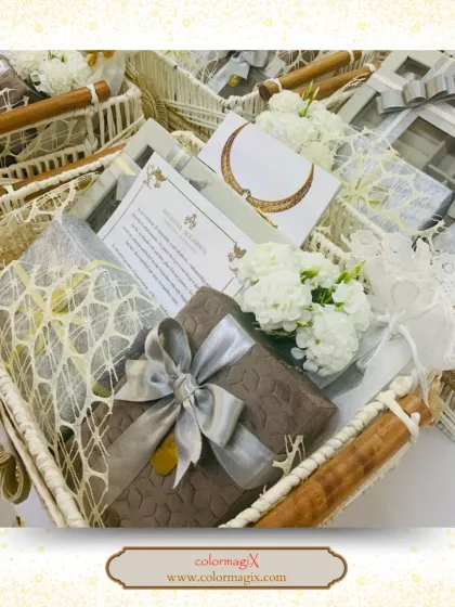 A beautiful white woven basket filled with elegantly wrapped gifts and white flowers. This hamper exudes a sense of purity and sophistication, perfect for serene celebrations.