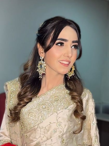 A candid smile that lights up the room. Her makeup was kept soft and romantic, with a focus on glowing skin and gently defined eyes, perfect for her engagement celebration.
