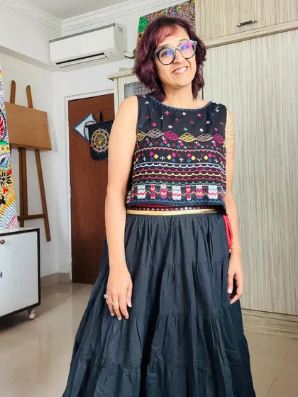Posing in my studio with my easel in the background.