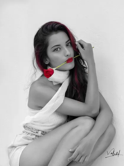 I love experimenting with creative edits. Here, I used a selective color technique on a black and white portrait to make the red rose, lips, and hair highlights pop, creating a bold and romantic statement.