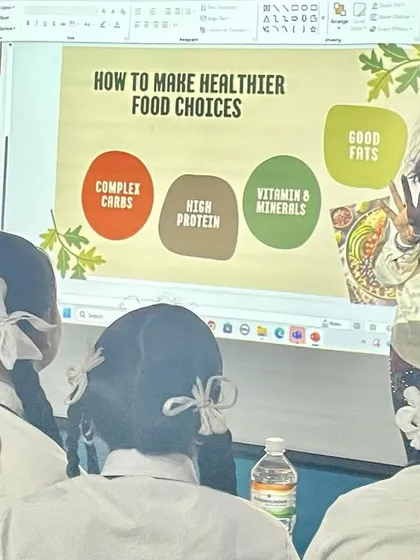 Educating the next generation on nutrition is a core part of my mission. Here, I'm explaining the fundamentals of healthy food choices to high school students, making wellness concepts accessible and relevant to their lives.