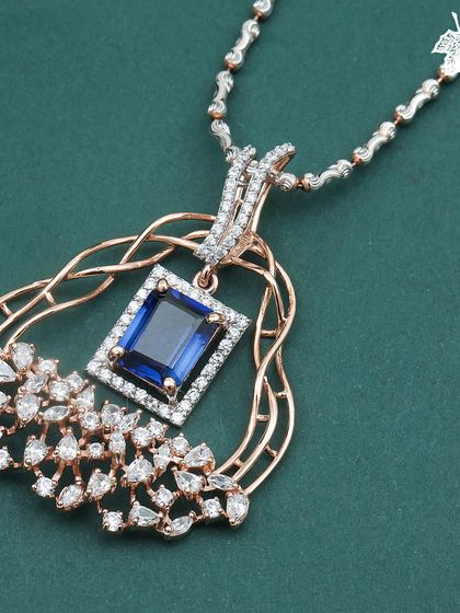 A detailed look at the Sapphire Dream pendant, highlighting the interwoven rose gold and diamond details.