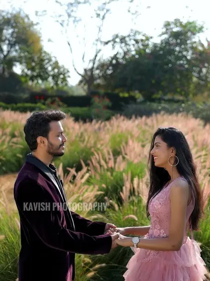 A classic romantic pose of the couple holding hands in a beautiful field, perfect for a save-the-date card.