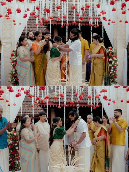 The sacred moment of the garland exchange during a traditional Kerala wedding ceremony, surrounded by the blessings of family.