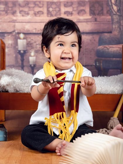 This little wizard is having so much fun with his magic wand. The genuine smile is what makes this photo truly magical.